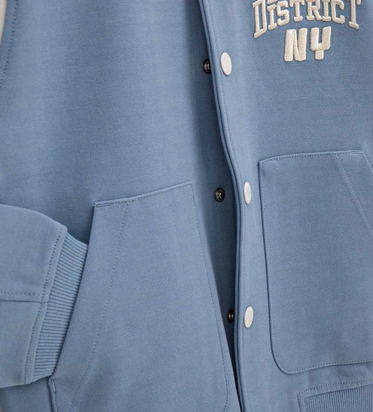 Γαλάζιο παιδικό bomber jacket Original Marines με λευκές λεπτομέρειες και τύπωμα "DENIM DISTRICT NY" στο στήθος, για αγόρια 5-14 ετών.
